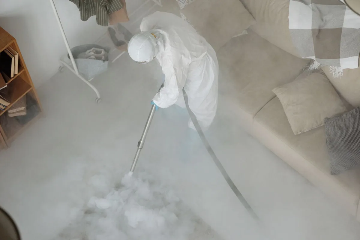 Biohazard cleanup technician in protective equipment, Baltimore, OH